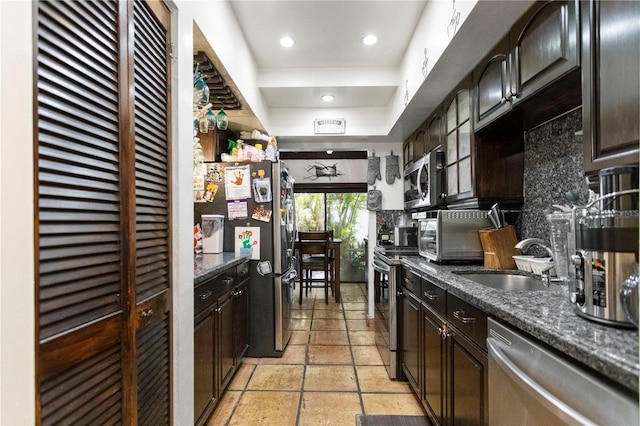 19440 NE 26th Ave Unit 53B, Miami, FL 33180 - kitchen featuring stainless steel appliances, a sink, decorative backsplash, dark brown cabinets, and recessed lighting