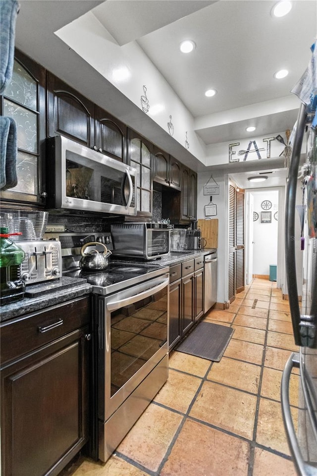 19440 NE 26th Ave Unit 53B, Miami, FL 33180 - kitchen with stainless steel appliances, tasteful backsplash, recessed lighting, dark brown cabinets, and dark countertops