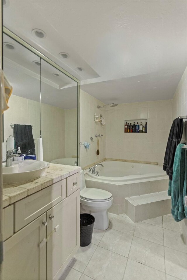 19440 NE 26th Ave Unit 53B, Miami, FL 33180 - full bathroom featuring tile patterned flooring, vanity, toilet, tiled shower / bath, and tile walls