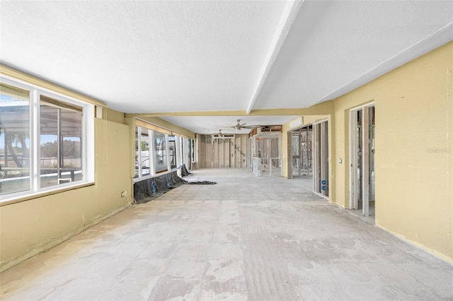 hall with a textured ceiling