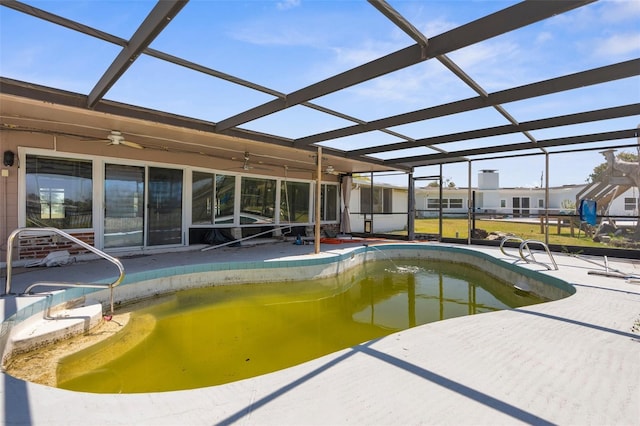 outdoor pool with a ceiling fan, a patio area, and a lanai