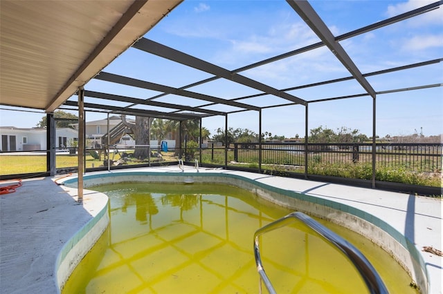 pool featuring glass enclosure and fence