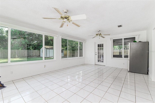 unfurnished sunroom with plenty of natural light and visible vents