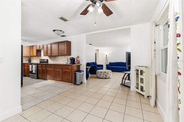 kitchen featuring light tile patterned flooring, electric stove, backsplash, and a ceiling fan