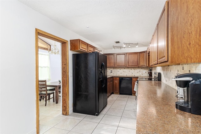 kitchen with brown cabinets, decorative backsplash, black appliances, and a textured ceiling