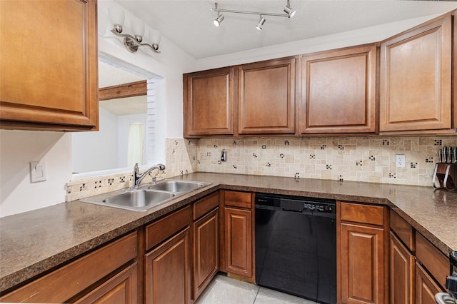 kitchen with black dishwasher, a sink, dark countertops, and tasteful backsplash