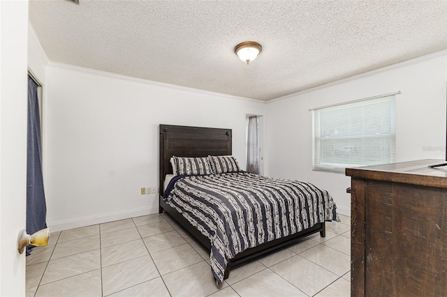 bedroom with a textured ceiling, ornamental molding, and light tile patterned floors