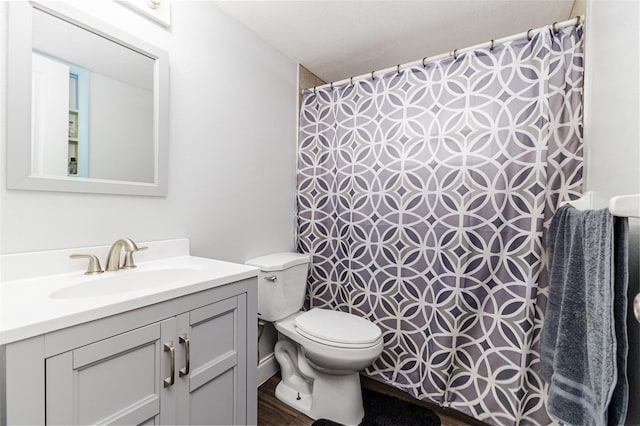 full bath with a shower with curtain, toilet, and vanity