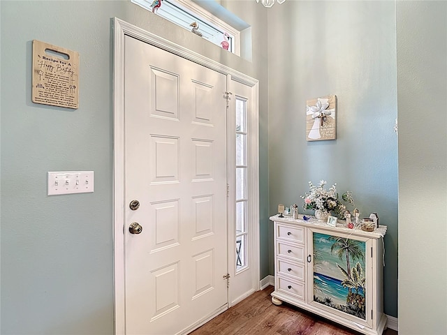 foyer entrance with baseboards and dark wood-style floors