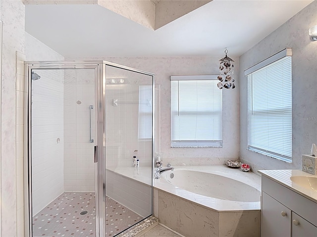 full bathroom with a stall shower, vanity, and a garden tub