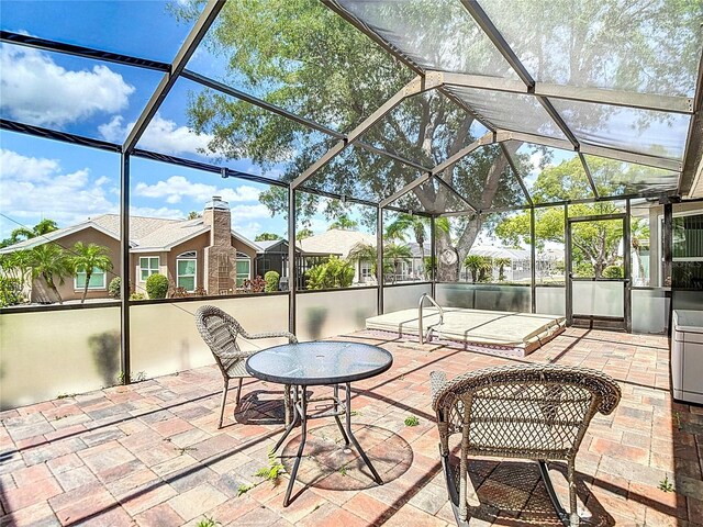 view of patio / terrace with a lanai
