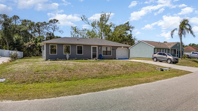ranch-style house with driveway and a garage