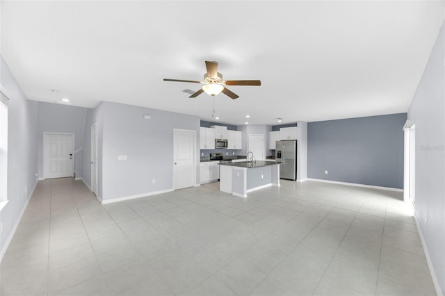 582 Royal Empress Dr, Ruskin, FL 33570 - unfurnished living room featuring ceiling fan and light tile patterned floors
