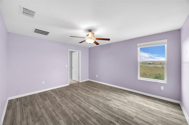 582 Royal Empress Dr, Ruskin, FL 33570 - unfurnished room featuring wood finished floors and ceiling fan