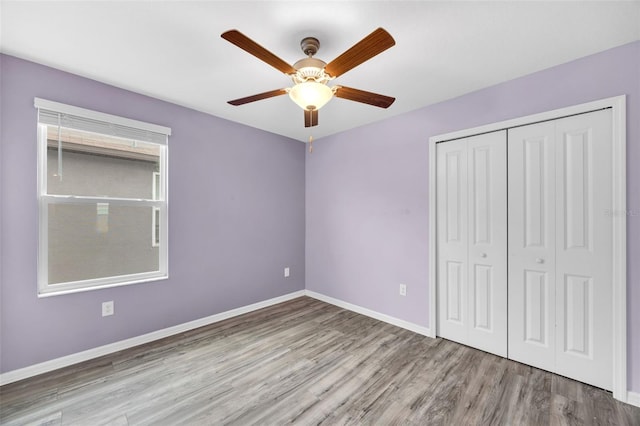 582 Royal Empress Dr, Ruskin, FL 33570 - unfurnished bedroom with wood finished floors, a closet, and ceiling fan