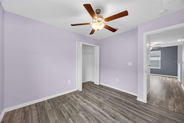 582 Royal Empress Dr, Ruskin, FL 33570 - unfurnished bedroom featuring wood finished floors, a closet, and a ceiling fan