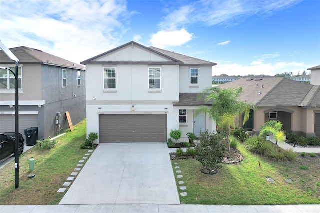 582 Royal Empress Dr, Ruskin, FL 33570 - view of front of home featuring stucco siding, concrete driveway, a garage, and a front lawn