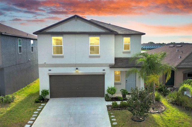 582 Royal Empress Dr, Ruskin, FL 33570 - view of front facade with stucco siding, concrete driveway, a garage, and a yard