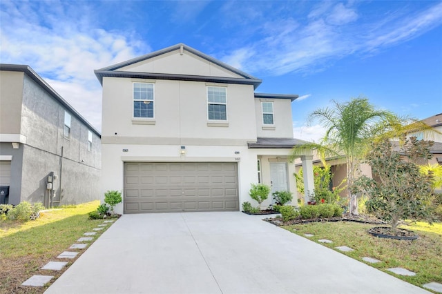 582 Royal Empress Dr, Ruskin, FL 33570 - view of front of house featuring stucco siding, driveway, and an attached garage