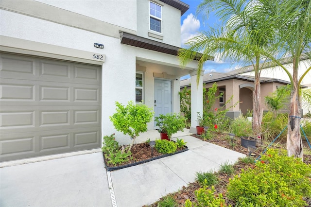 582 Royal Empress Dr, Ruskin, FL 33570 - property entrance featuring stucco siding and an attached garage
