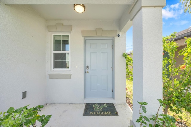 582 Royal Empress Dr, Ruskin, FL 33570 - entrance to property with stucco siding and a security system