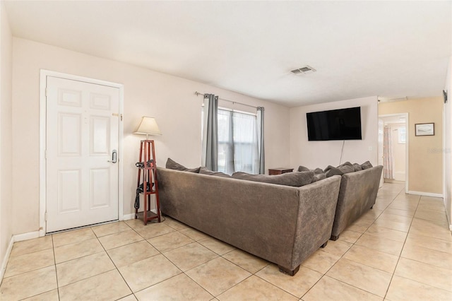 living room with visible vents, baseboards, and light tile patterned flooring