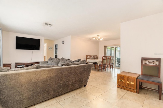 living area featuring light tile patterned floors and visible vents