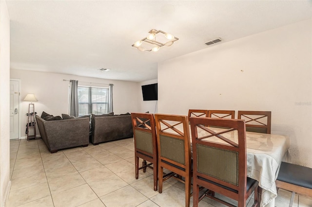 dining area with light tile patterned flooring and visible vents