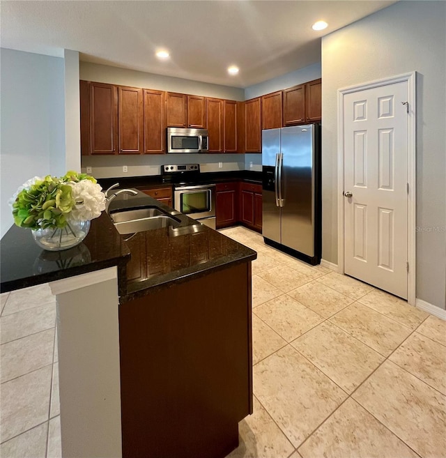 5221 Bannister Park Ln, Lithia, FL 33547 - kitchen featuring recessed lighting, a sink, dark stone countertops, appliances with stainless steel finishes, and light tile patterned floors