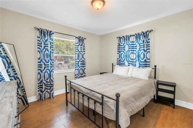 bedroom with baseboards and hardwood / wood-style floors