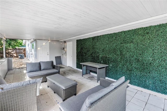 view of patio featuring an outdoor living space and fence