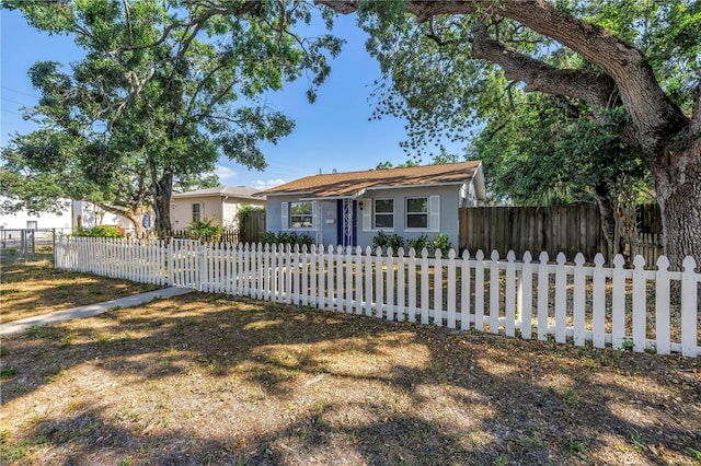 ranch-style house with a fenced front yard