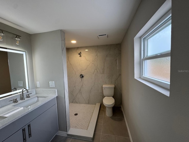 full bathroom featuring vanity, a marble finish shower, tile patterned floors, and toilet
