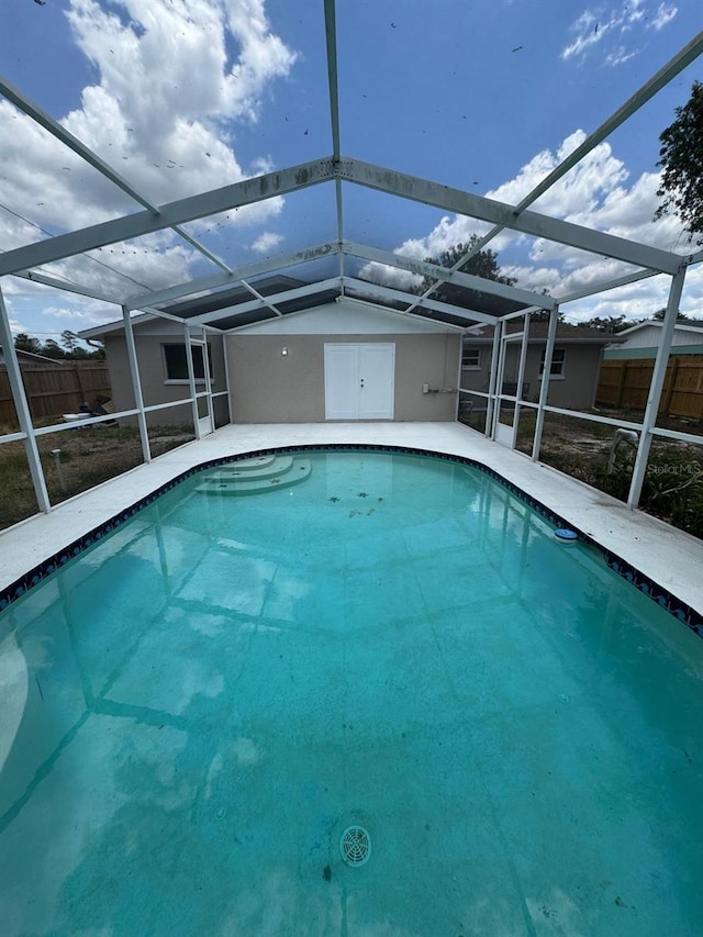 pool featuring fence and a lanai