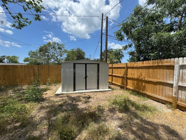 view of shed with a fenced backyard