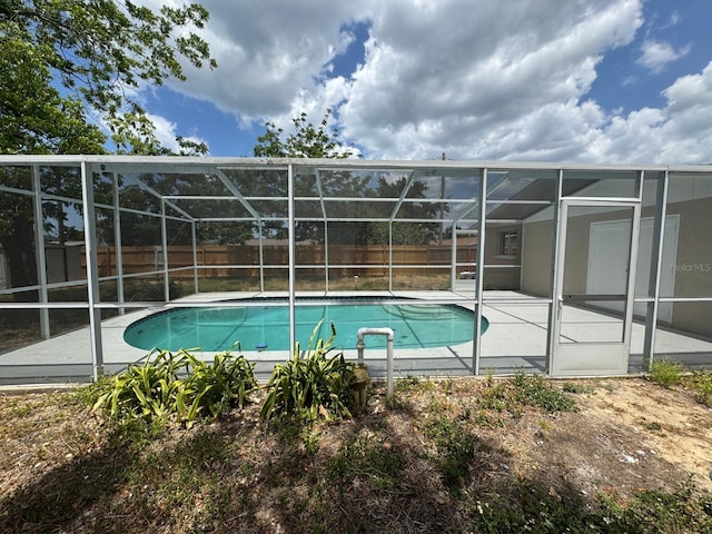 view of swimming pool with a fenced backyard, a fenced in pool, a patio area, and a lanai