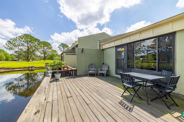 13512 Palmwood Ln Unit 13512, Tampa, FL 33618 - wooden deck with a water view, outdoor dining area, and a lawn