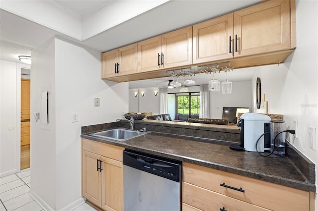 13512 Palmwood Ln Unit 13512, Tampa, FL 33618 - kitchen with stainless steel dishwasher, light brown cabinets, a sink, and dark countertops