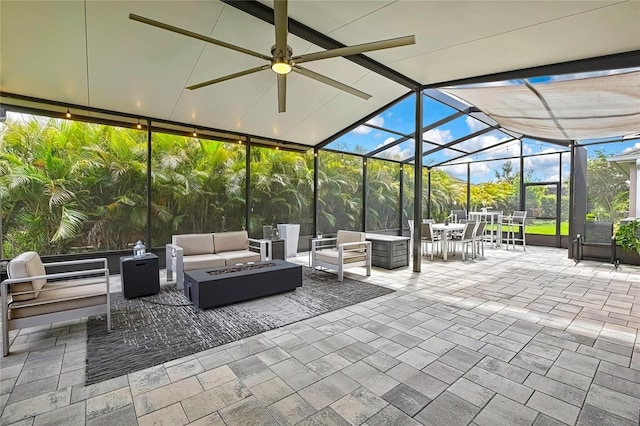 view of patio / terrace featuring an outdoor living space with a fire pit, outdoor dining area, and a lanai