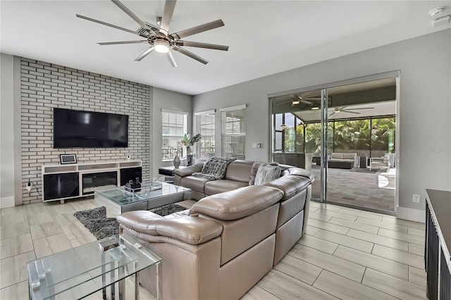 living room featuring baseboards and a ceiling fan