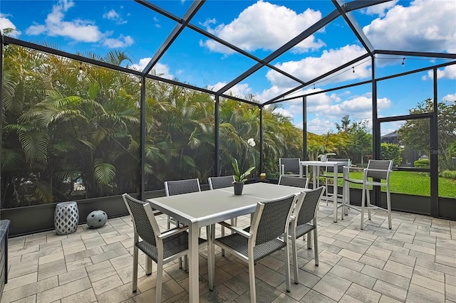 view of patio featuring a lanai and outdoor dining area