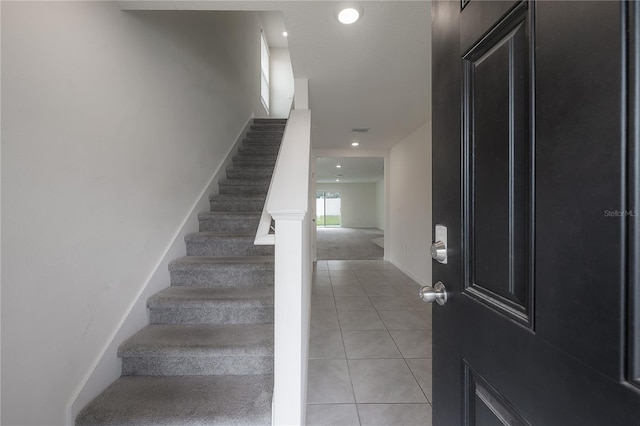 staircase featuring recessed lighting, tile patterned floors, and baseboards