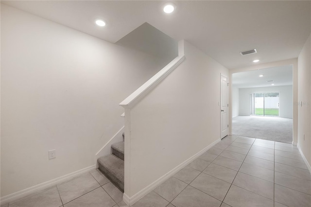stairway with recessed lighting, tile patterned floors, visible vents, and baseboards