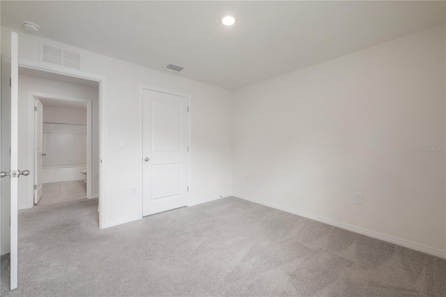 unfurnished bedroom featuring carpet flooring, baseboards, visible vents, and recessed lighting