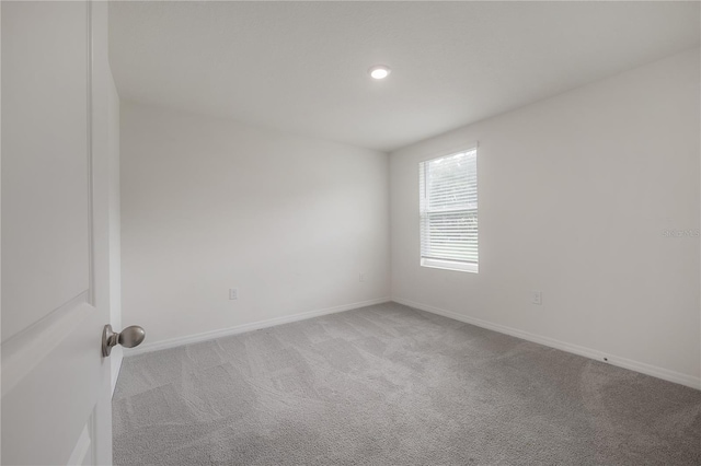 carpeted spare room with baseboards and recessed lighting