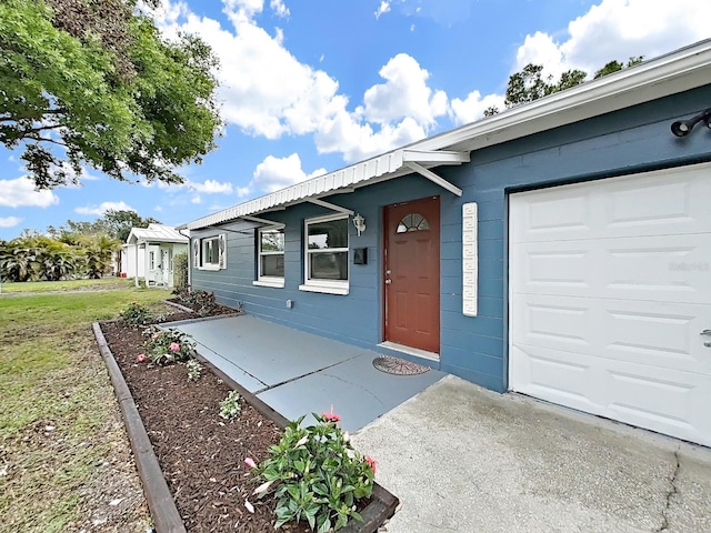 5772 4th Ave N, Saint Petersburg, FL 33710 - view of front facade featuring concrete block siding, a front lawn, and a garage