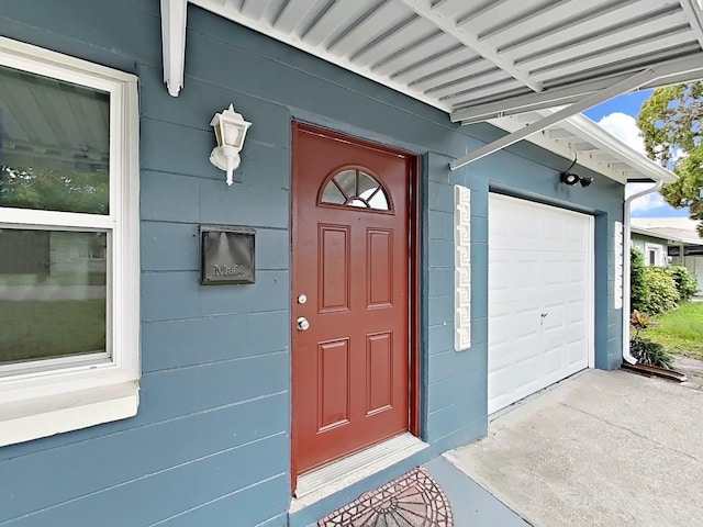 5772 4th Ave N, Saint Petersburg, FL 33710 - doorway to property with a garage and concrete driveway