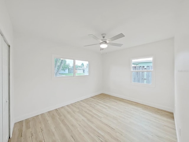 5772 4th Ave N, Saint Petersburg, FL 33710 - unfurnished room featuring wood finished floors, ceiling fan, baseboards, and plenty of natural light
