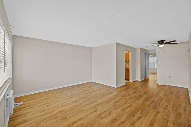 2366 Shelley St Unit 7, Clearwater, FL 33765 - unfurnished living room with baseboards, ceiling fan, and light wood-style flooring