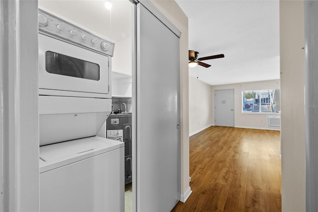 2366 Shelley St Unit 7, Clearwater, FL 33765 - clothes washing area with laundry area, a ceiling fan, stacked washer and dryer, wood finished floors, and electric water heater